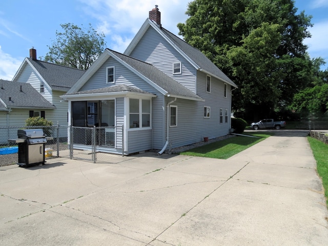 1513 Joy Ave, Jackson, MI 49203 - rear view of property with a chimney, roof with shingles, and a gate