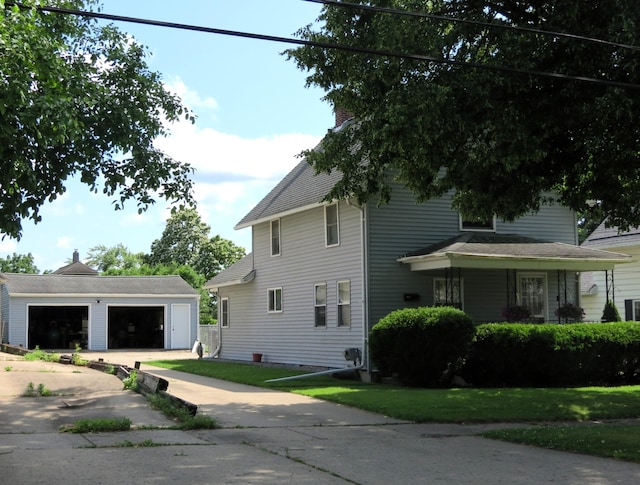 1513 Joy Ave, Jackson, MI 49203 - view of home's exterior featuring an outdoor structure, a garage, and a chimney
