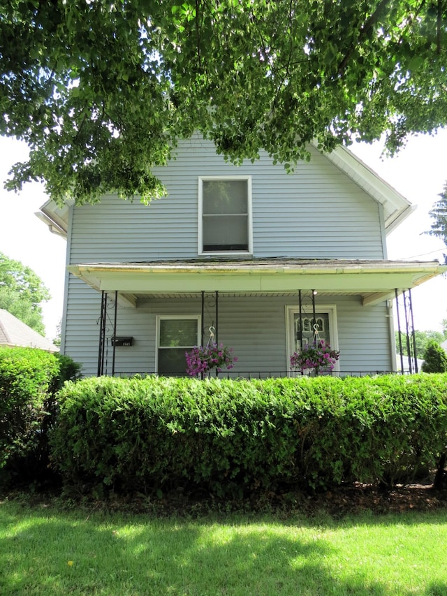 1513 Joy Ave, Jackson, MI 49203 - view of front of home with a porch and a front lawn