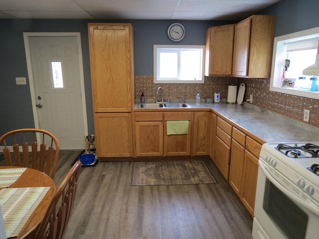 1513 Joy Ave, Jackson, MI 49203 - kitchen featuring white range with gas cooktop, dark wood-style flooring, a drop ceiling, and backsplash