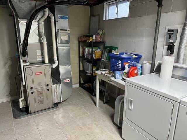 2975 Princeton Ct, Muskegon, MI 49441 - below grade area with washing machine and clothes dryer, light tile patterned floors, and concrete block wall
