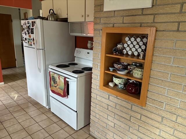 2975 Princeton Ct, Muskegon, MI 49441 - kitchen with white appliances and light tile patterned floors