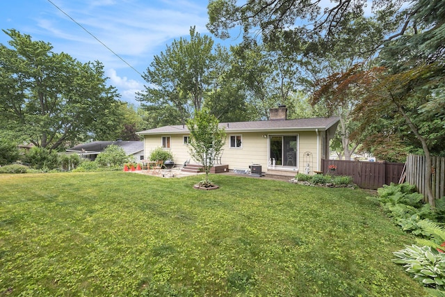 2975 Princeton Ct, Muskegon, MI 49441 - back of house with a chimney, entry steps, and an outdoor fire pit