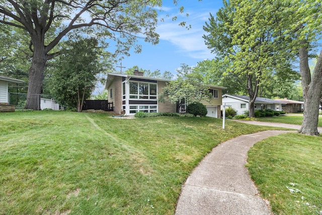 2975 Princeton Ct, Muskegon, MI 49441 - view of front facade featuring a chimney and concrete driveway