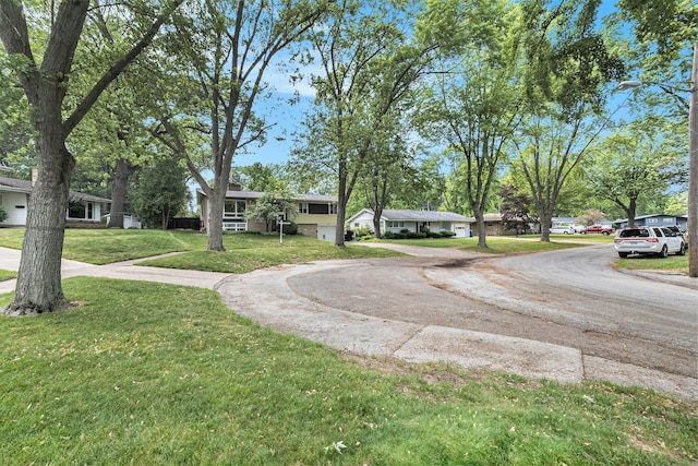 2975 Princeton Ct, Muskegon, MI 49441 - view of front of home featuring curved driveway, a front yard, and a residential view