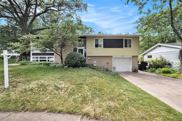 2975 Princeton Ct, Muskegon, MI 49441 - tri-level home featuring brick siding, driveway, an attached garage, and a front yard