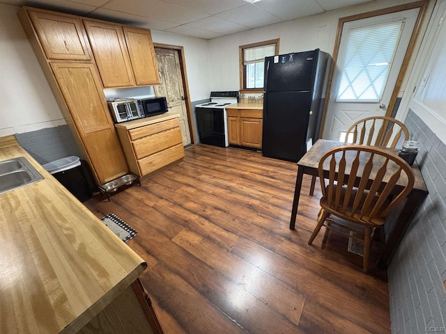 7408 Carleton Rd, Clayton, MI 49235 - kitchen featuring electric range, freestanding refrigerator, dark wood-type flooring, and a paneled ceiling