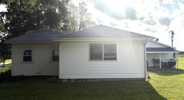7408 Carleton Rd, Clayton, MI 49235 - back of house with a yard and a shingled roof