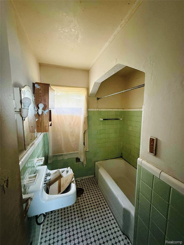 18241 Kentfield St, Detroit, MI 48219 - bathroom with tile patterned floors, wainscoting, tile walls, and bathtub / shower combination