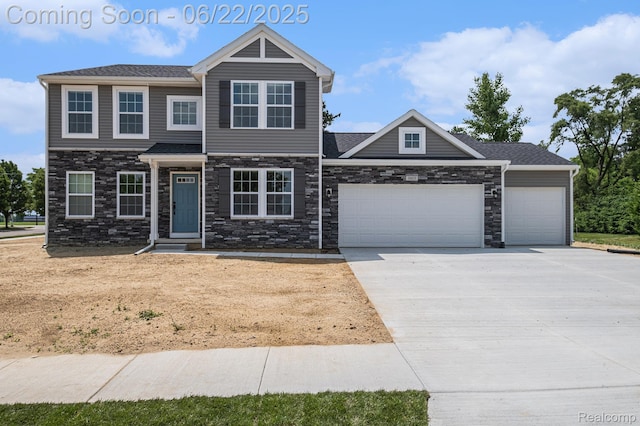 1013 Lancaster St, Lapeer, MI 48446 - view of front facade with a garage, driveway, and stone siding