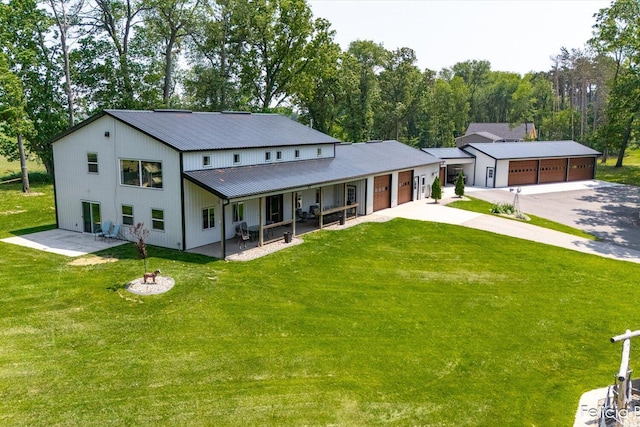 2539 Daisy Ln, Middleville, MI 49333 - back of property with concrete driveway, a lawn, and a metal roof