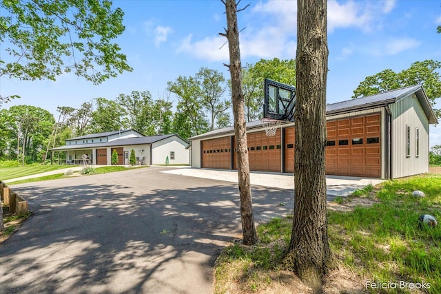 2539 Daisy Ln, Middleville, MI 49333 - mid-century home featuring a detached garage and a metal roof