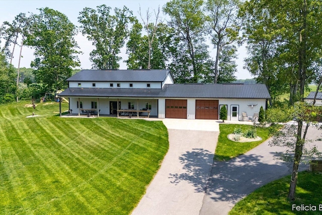 2539 Daisy Ln, Middleville, MI 49333 - view of front facade featuring a garage, a front lawn, driveway, and a porch