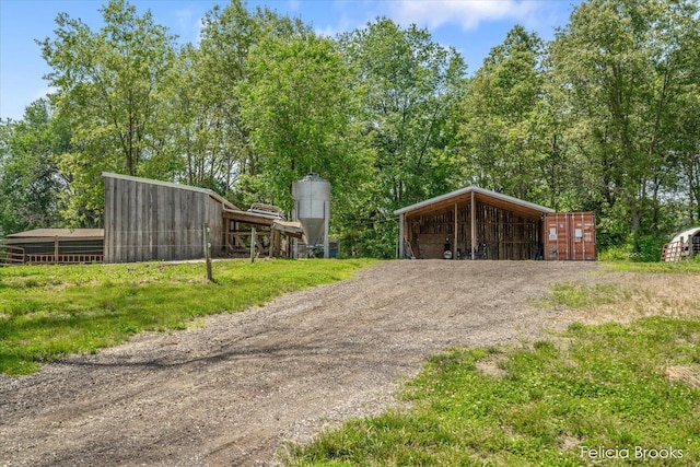 2539 Daisy Ln, Middleville, MI 49333 - garage featuring dirt driveway and a detached carport