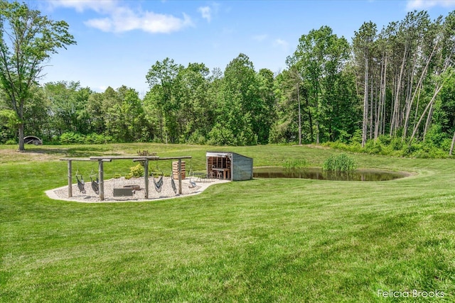 2539 Daisy Ln, Middleville, MI 49333 - view of grassy yard with an outdoor structure and a view of trees