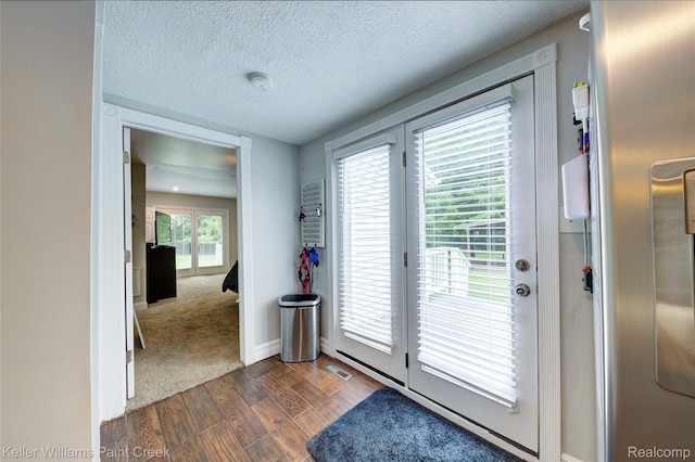 1320 W Drahner Rd, Oxford, MI 48371 - entryway with dark wood finished floors and a textured ceiling