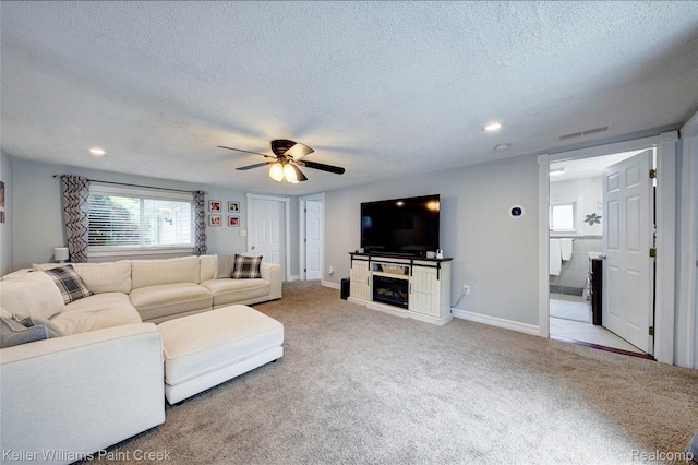 1320 W Drahner Rd, Oxford, MI 48371 - living room featuring a textured ceiling, light carpet, ceiling fan, recessed lighting, and a fireplace