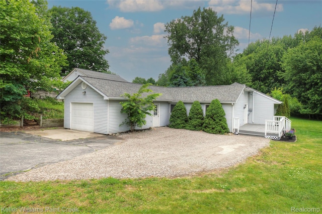 1320 W Drahner Rd, Oxford, MI 48371 - single story home featuring asphalt driveway, a deck, roof with shingles, a front lawn, and an attached garage