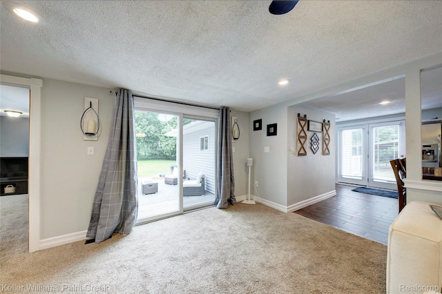 1320 W Drahner Rd, Oxford, MI 48371 - unfurnished living room featuring carpet floors, healthy amount of natural light, a textured ceiling, and recessed lighting