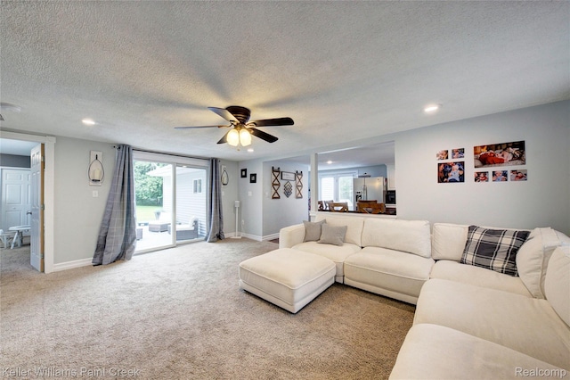 1320 W Drahner Rd, Oxford, MI 48371 - living room with light colored carpet, ceiling fan, recessed lighting, a textured ceiling, and healthy amount of natural light