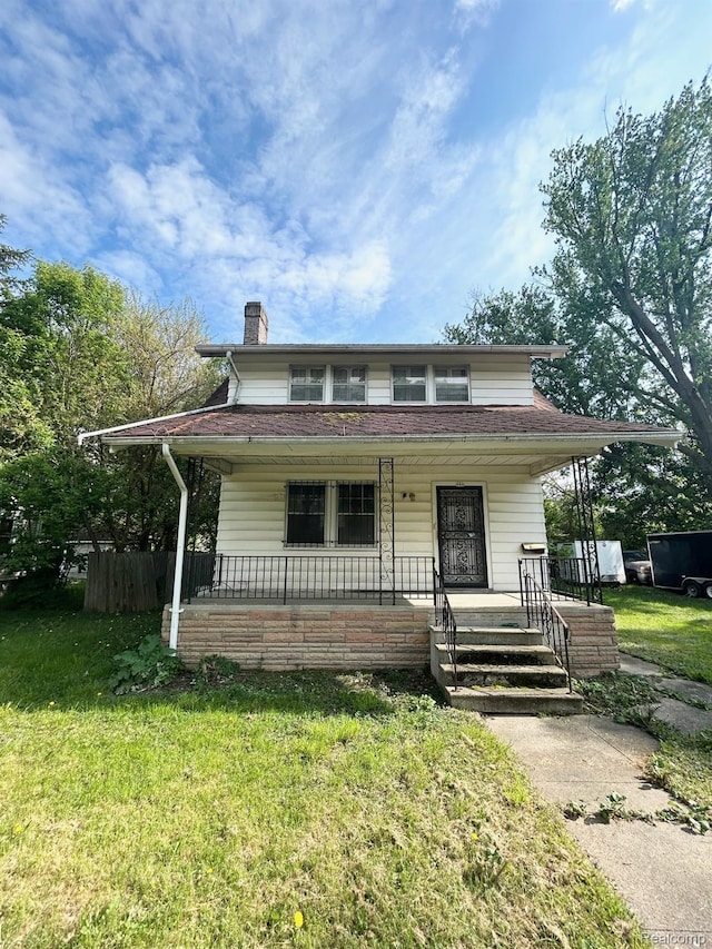 523 Grace St, Flint, MI 48503 - view of front of property featuring a chimney, a front lawn, and covered porch