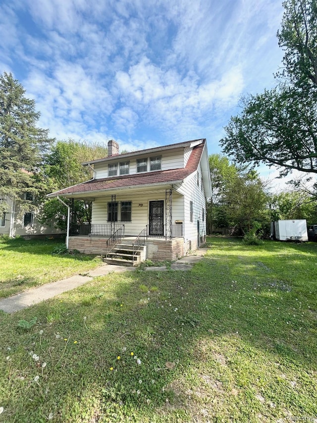 523 Grace St, Flint, MI 48503 - view of front of property featuring a porch, a chimney, and a front lawn