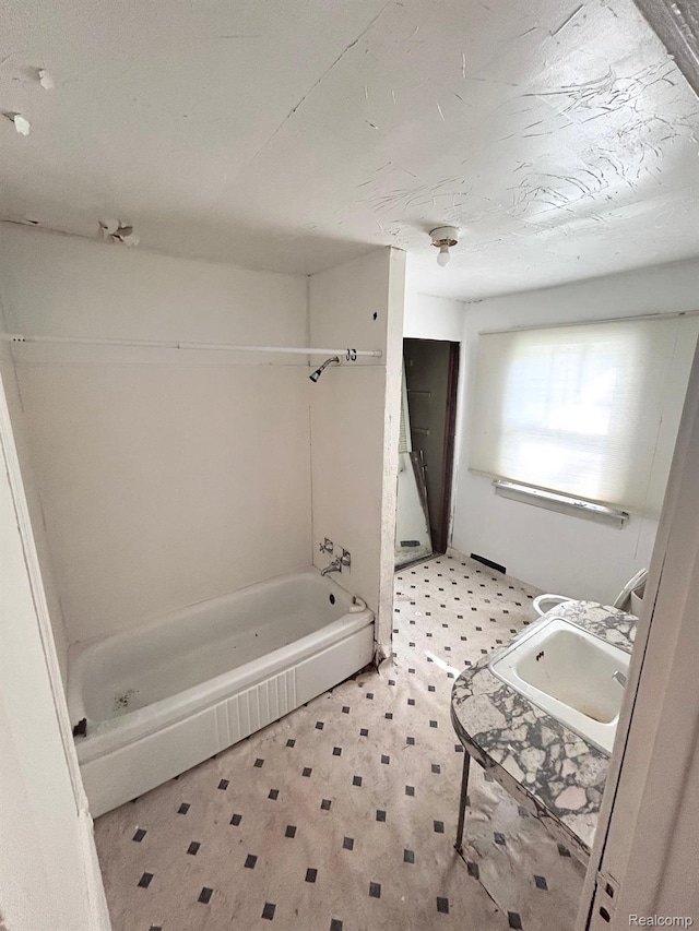 523 Grace St, Flint, MI 48503 - bathroom with vanity, tile patterned floors, and washtub / shower combination