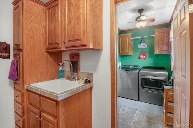 3933 Benjamin Way, Monroe, MI 48161 - laundry room featuring cabinet space, washing machine and clothes dryer, a ceiling fan, light tile patterned flooring, and ornamental molding