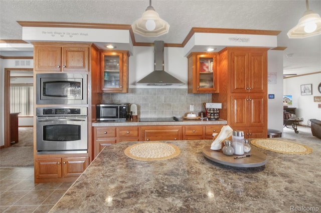 3933 Benjamin Way, Monroe, MI 48161 - kitchen featuring stainless steel appliances, wall chimney exhaust hood, ornamental molding, brown cabinets, and a textured ceiling