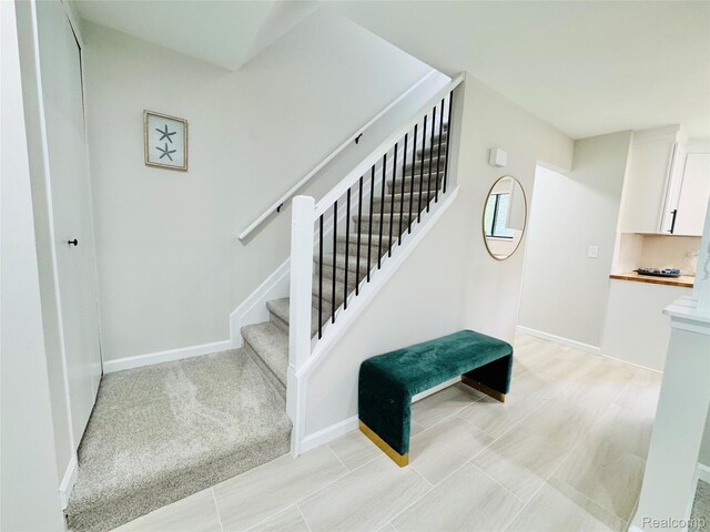 694 Robar Cir, Commerce Twp, MI 48386 - staircase with baseboards