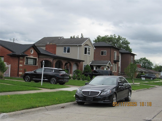 5962 Mcmillian St, Dearborn Heights, MI 48127 - view of front of house with a front yard and brick siding