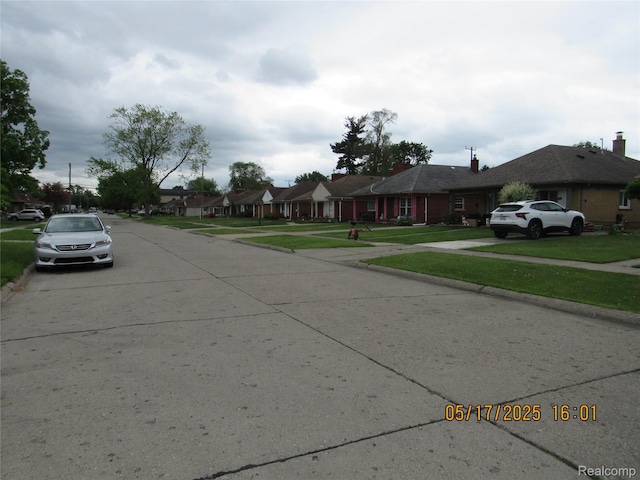 5962 Mcmillian St, Dearborn Heights, MI 48127 - view of concrete street with curbs, sidewalks, and a residential view
