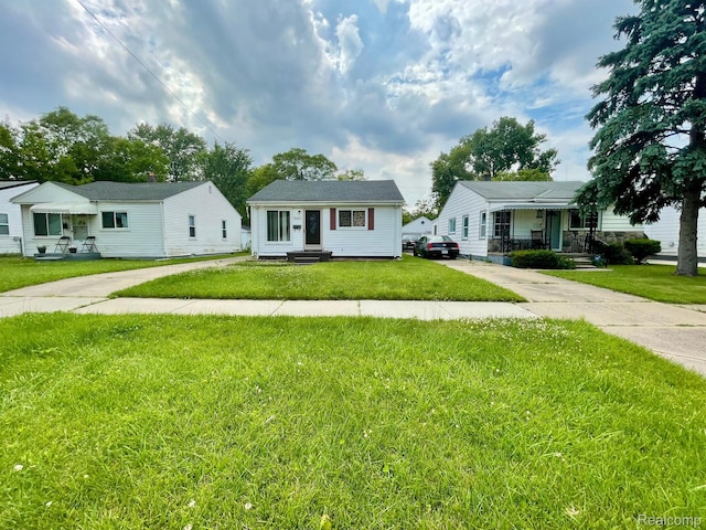 20817 Atlantic Ave, Warren, MI 48091 - bungalow featuring entry steps, a front yard, and concrete driveway