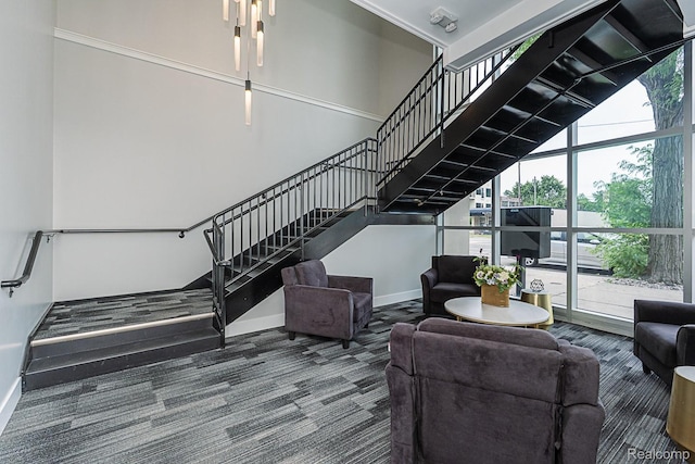 1021 S Washington Ave Unit G, Royal Oak, MI 48067 - living room featuring carpet floors, a towering ceiling, plenty of natural light, and stairs