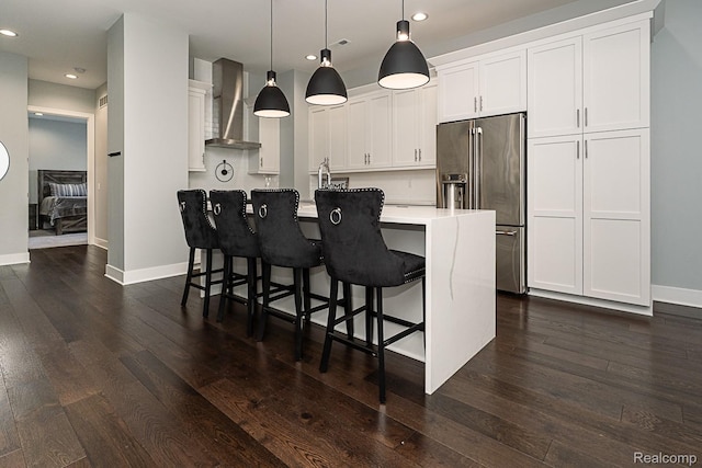 1021 S Washington Ave Unit G, Royal Oak, MI 48067 - kitchen featuring wall chimney range hood, high quality fridge, recessed lighting, white cabinets, and light countertops