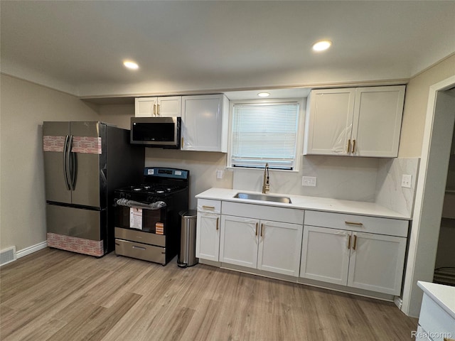 14276 Hobart Ave, Warren, MI 48089 - kitchen with appliances with stainless steel finishes, light wood-style flooring, light countertops, and recessed lighting