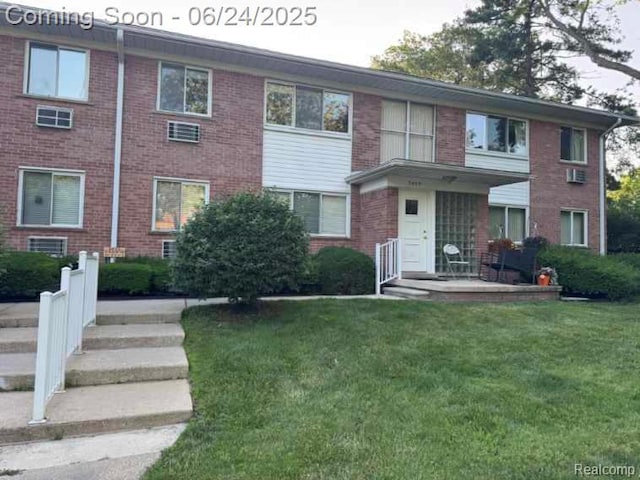3400 Elizabeth Dr Unit 4, Trenton, MI 48183 - view of front facade featuring a front yard, brick siding, and cooling unit