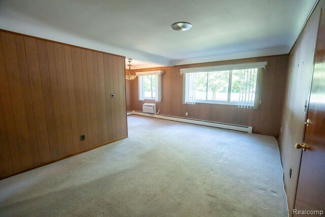 3400 Elizabeth Dr Unit 4, Trenton, MI 48183 - carpeted empty room featuring baseboard heating, a chandelier, wood walls, and a wall mounted air conditioner
