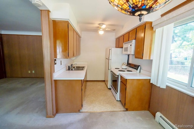 3400 Elizabeth Dr Unit 4, Trenton, MI 48183 - kitchen featuring white appliances, a baseboard radiator, light countertops, light colored carpet, and brown cabinets