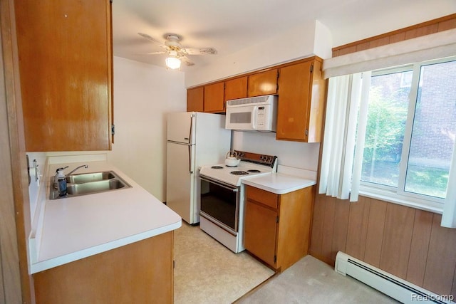 3400 Elizabeth Dr Unit 4, Trenton, MI 48183 - kitchen featuring white appliances, a baseboard heating unit, plenty of natural light, light countertops, and wooden walls