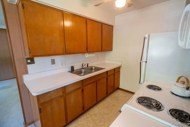 3400 Elizabeth Dr Unit 4, Trenton, MI 48183 - kitchen featuring white appliances, light countertops, a ceiling fan, and brown cabinetry