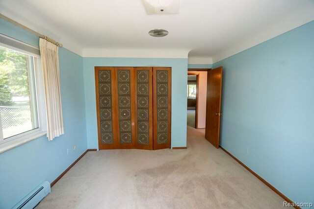 3400 Elizabeth Dr Unit 4, Trenton, MI 48183 - unfurnished bedroom with a baseboard radiator, multiple windows, and carpet