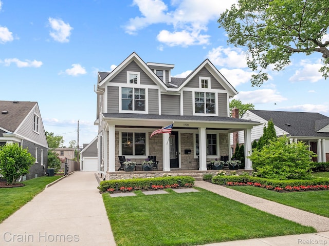 1790 Washington Blvd, Birmingham, MI 48009 - craftsman house with a porch, stone siding, a front yard, and a detached garage
