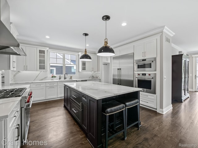 1790 Washington Blvd, Birmingham, MI 48009 - kitchen featuring range hood, high quality appliances, crown molding, a center island, and white cabinets