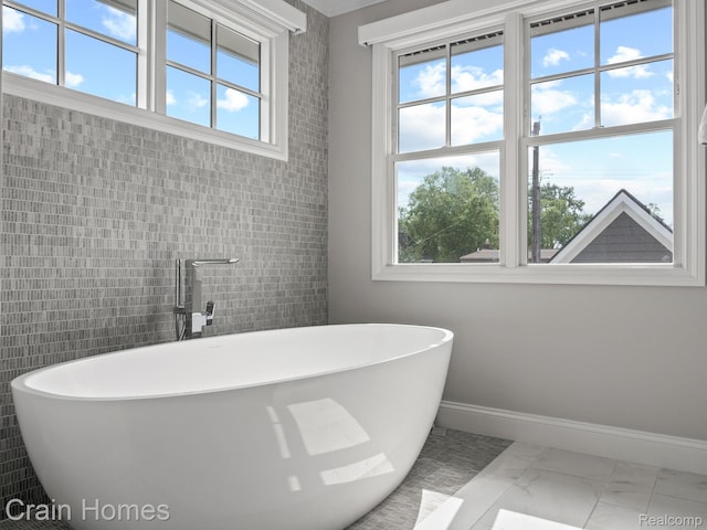 1790 Washington Blvd, Birmingham, MI 48009 - bathroom with plenty of natural light, marble finish flooring, and a soaking tub