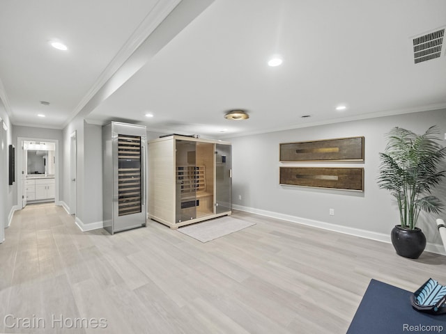 1790 Washington Blvd, Birmingham, MI 48009 - workout room with wine cooler, ornamental molding, recessed lighting, and light wood-style floors