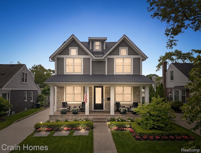 1790 Washington Blvd, Birmingham, MI 48009 - view of front of house featuring covered porch, stone siding, and a front lawn