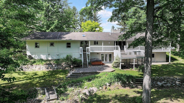 4301B W Sanborn Rd, Lake City, MI 49651 - rear view of property featuring french doors, a deck, stairs, and a hot tub