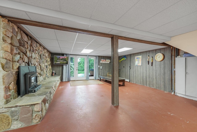 4301B W Sanborn Rd, Lake City, MI 49651 - basement featuring a wood stove, a drop ceiling, and wood walls