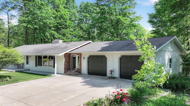 4301B W Sanborn Rd, Lake City, MI 49651 - single story home featuring a garage, driveway, a shingled roof, and a chimney